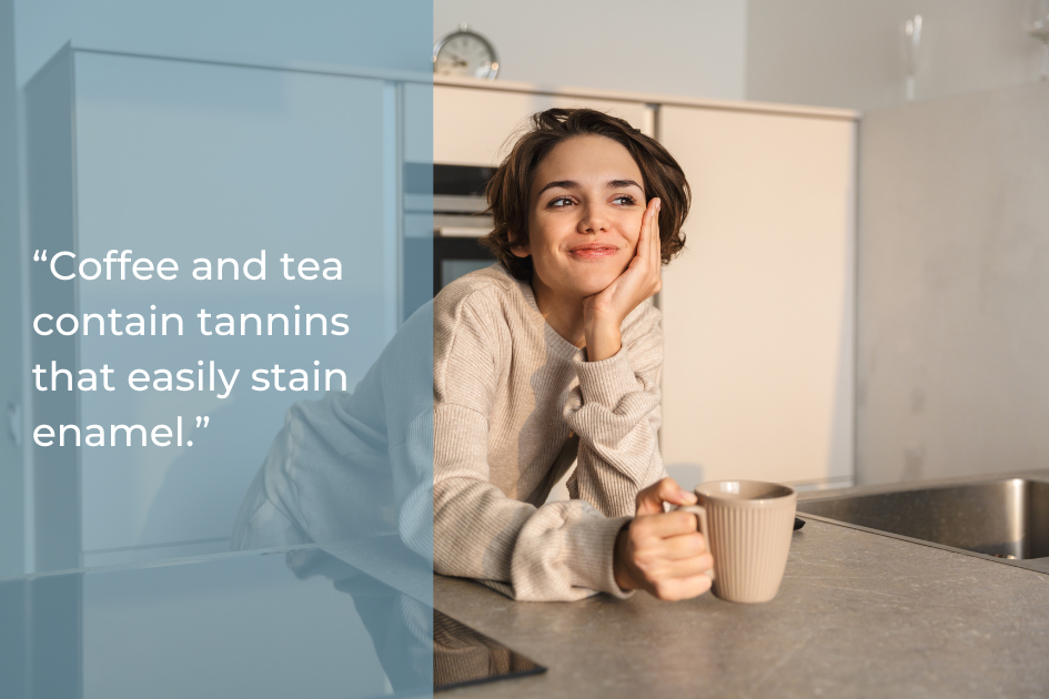 A person leans on a kitchen counter holding a mug. Text reads: “Coffee and tea contain tannins that easily stain enamel, making teeth whitening essential for a brighter smile.”.
