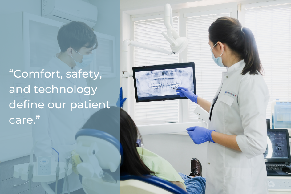 A dentist wearing a mask and gloves shows a dental X-ray on a monitor to a seated patient during a dental examination at Prairie Star Dental in a modern, well-lit dental office.