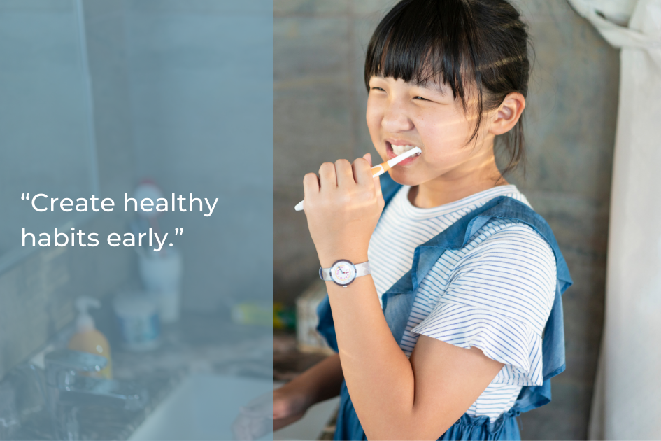 A young girl brushes her teeth in a bathroom. Text reads: “Create healthy habits early for kids dental health.”.